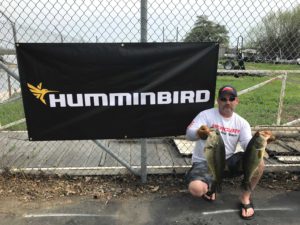 man with two large bass Humminbird sponsor