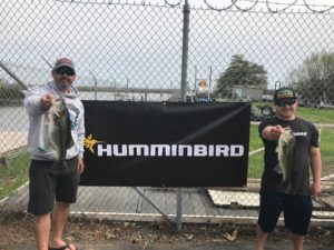 Two men with large bass Humminbird sponsor
